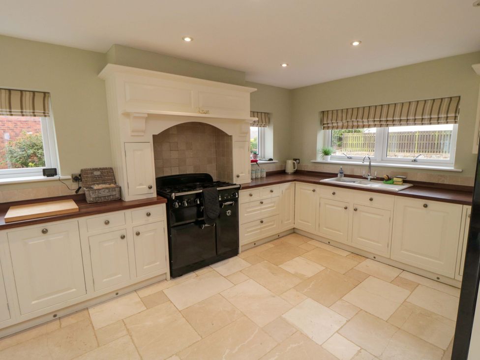 A kitchen with cabinets and a stove at Wyvill House in Cayton