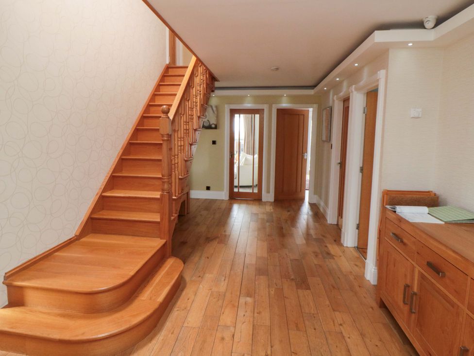 A hallway with stairs and doors at Wyvill House in Cayton