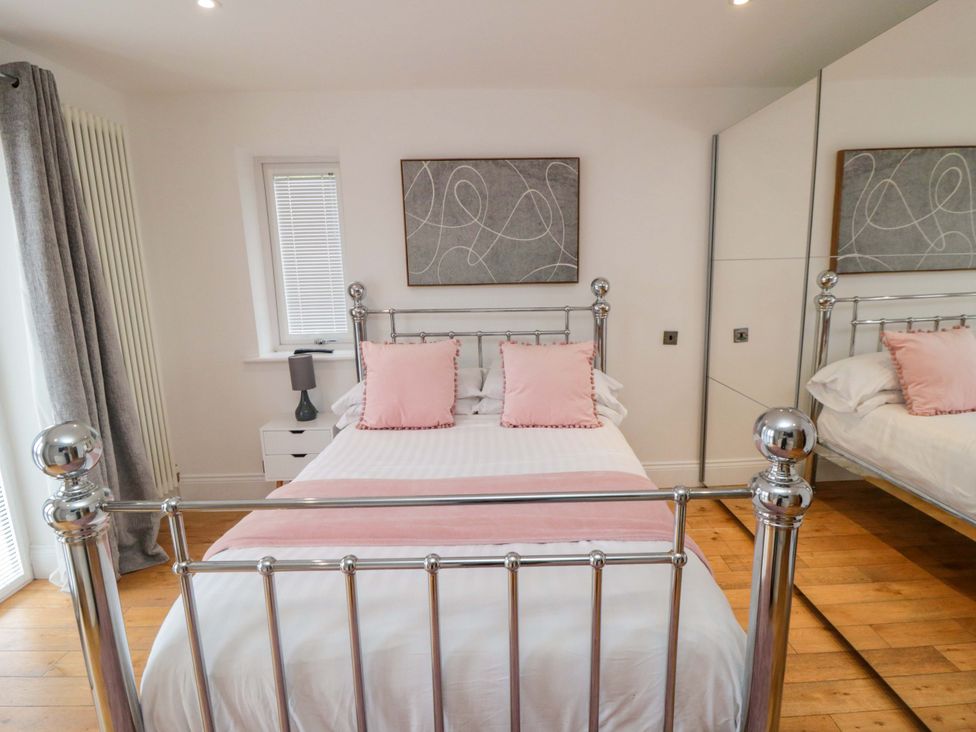 A bedroom with a bed and nightstand at Wyvill House Cayton