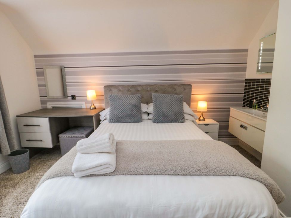 A bedroom with a bed and desk at Wyvill House in Cayton
