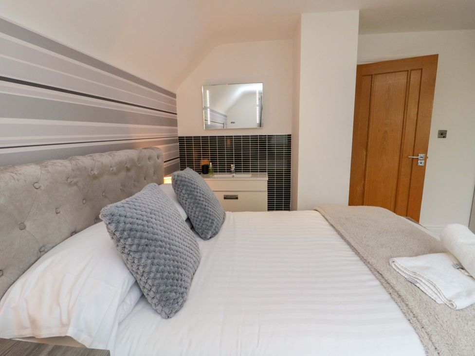 A bedroom with a bed and a cabinet at Wyvill House in Cayton