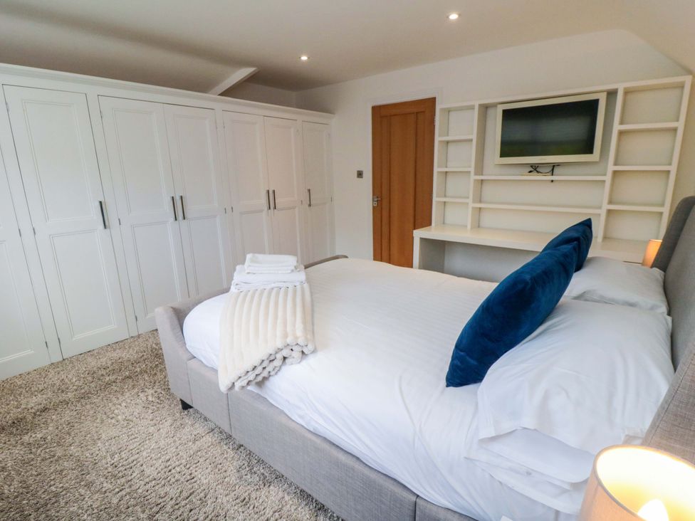 A bedroom with a bed and wardrobe at Wyvill House in Cayton