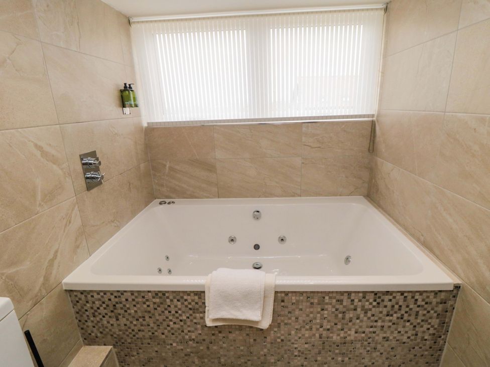 A hot tub with a towel beside it at Wyvill House in Cayton