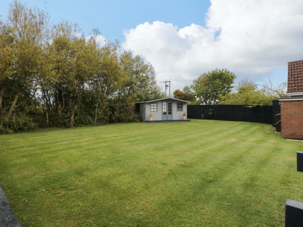 A garden with a shed and trees at Wyvill House in Cayton