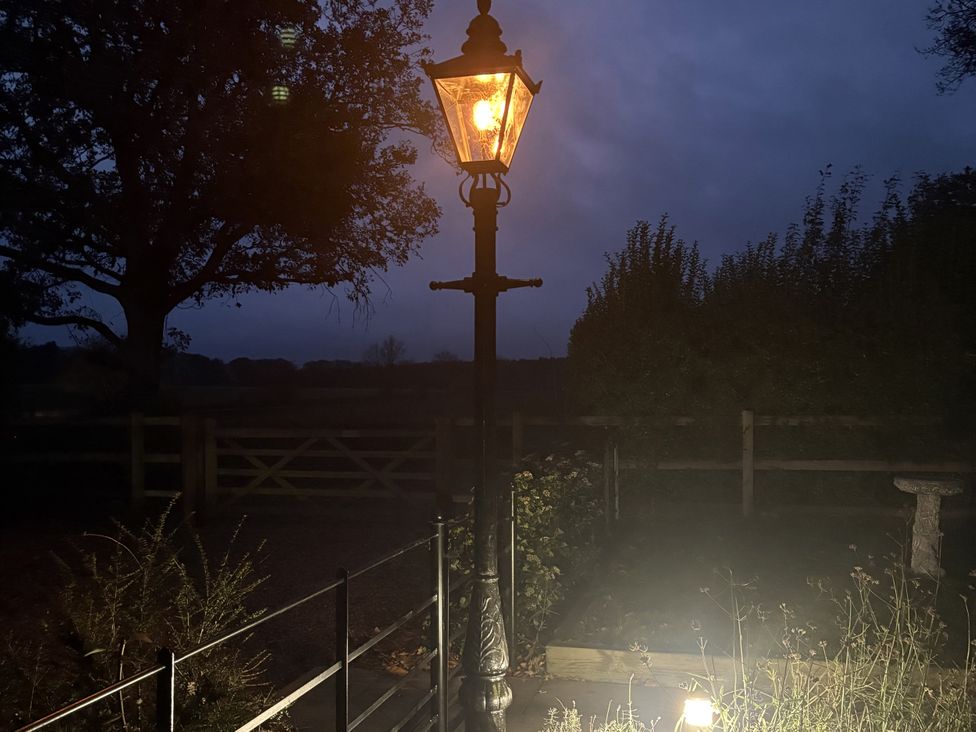 A lamp post illuminating a garden area at High House in Southrepps