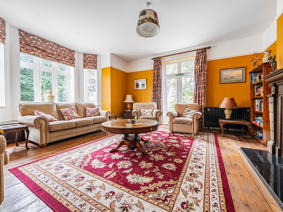 A living room with a sofa and coffee table at High House in Southrepps