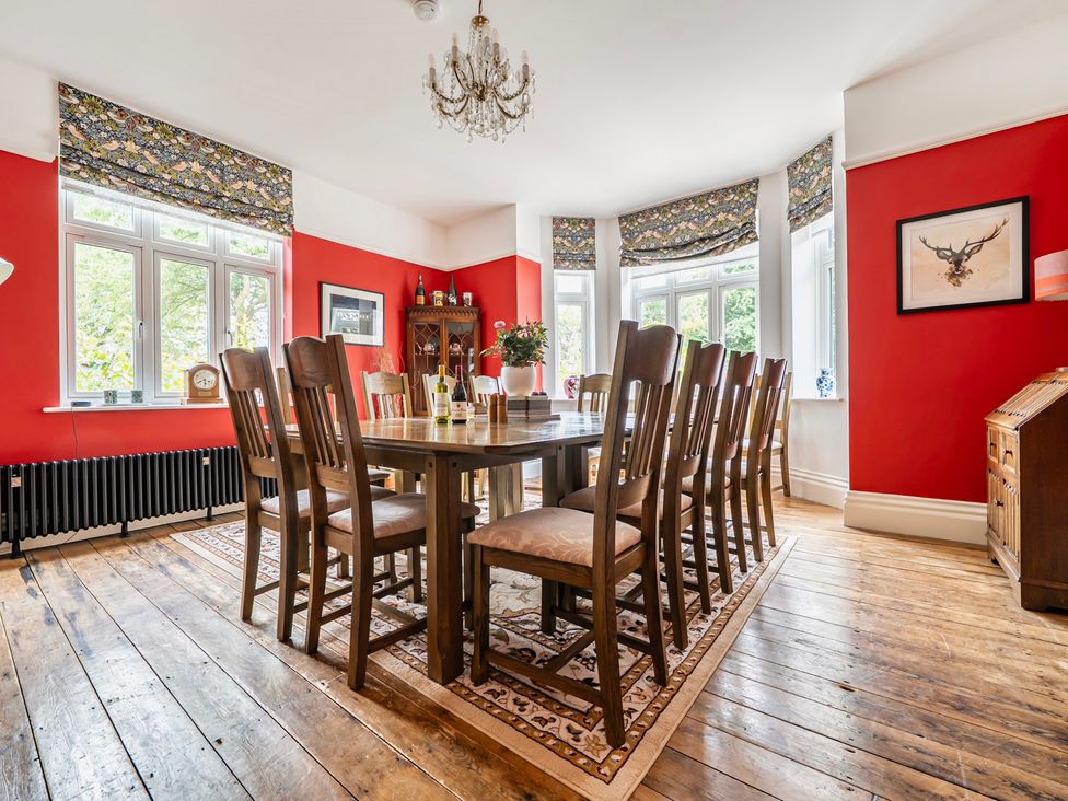 A dining room with a large table and chairs at High House in Southrepps