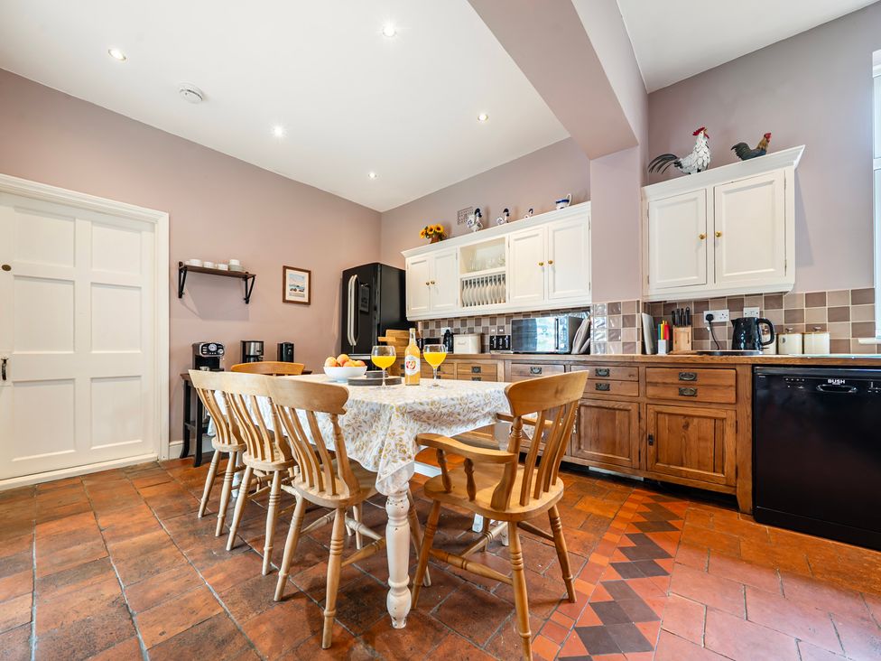 A kitchen with a table and chairs at High House in Southrepps