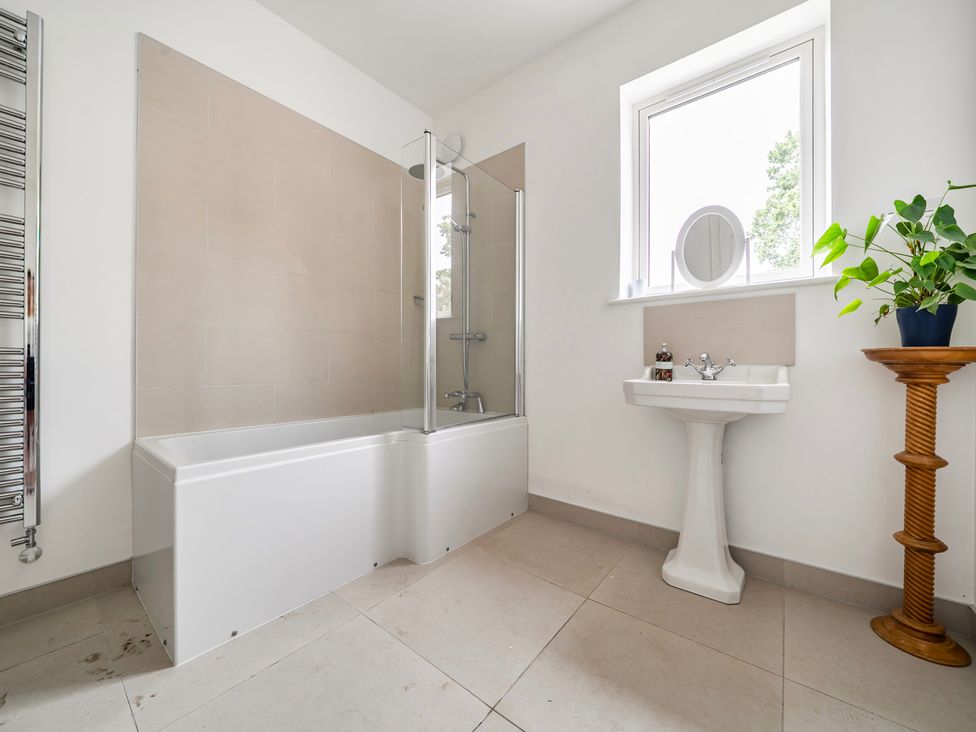 A bathroom with bathtub, sink and shower at High House in Southrepps