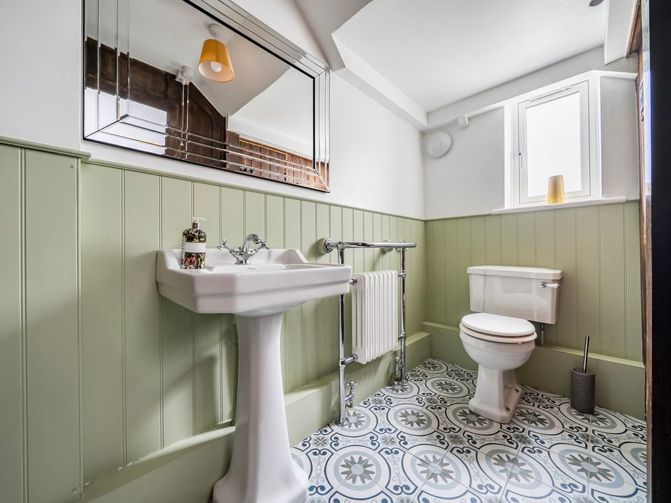 A bathroom with a sink and toilet at High House in Southrepps