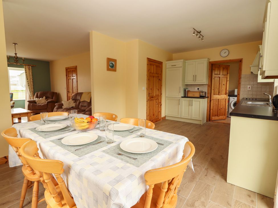 A dining room with a table set for a meal at 29 Church Field in Doonbeg, County Clare