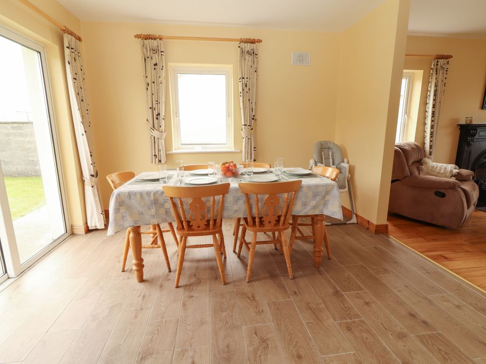 A dining room with a table and chairs at 29 Church Field Doonbeg, County Clare