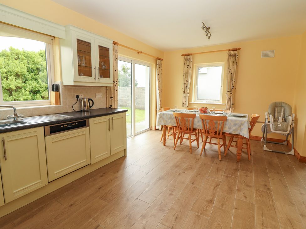 A kitchen with a dining table and chairs at 29 Church Field, Doonbeg, County Clare