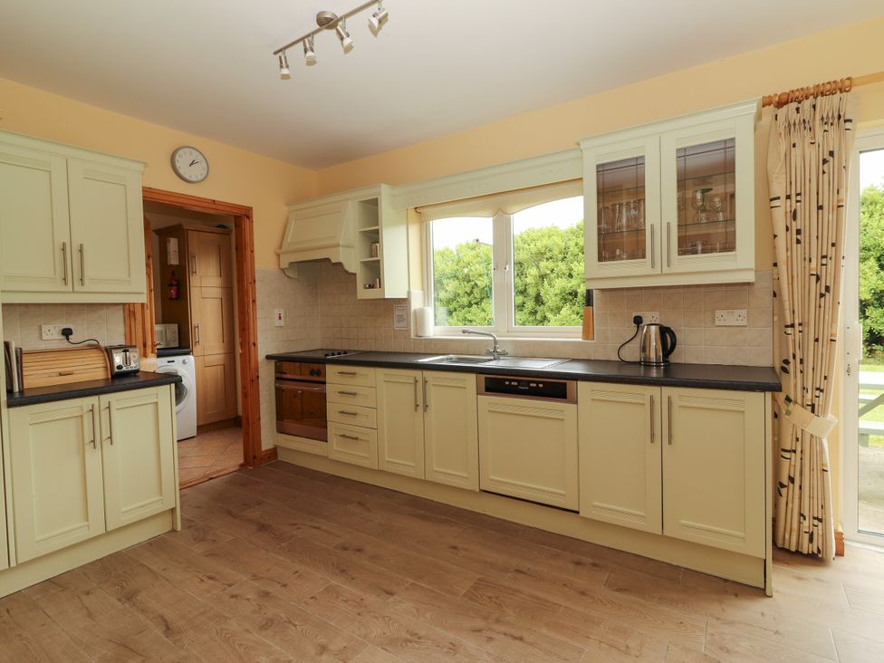 A kitchen with cabinets and a sink at 29 Church Field in Doonbeg, County Clare