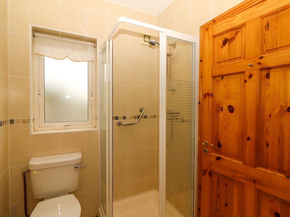 A bathroom with a shower and toilet at 29 Church Field Doonbeg, County Clare