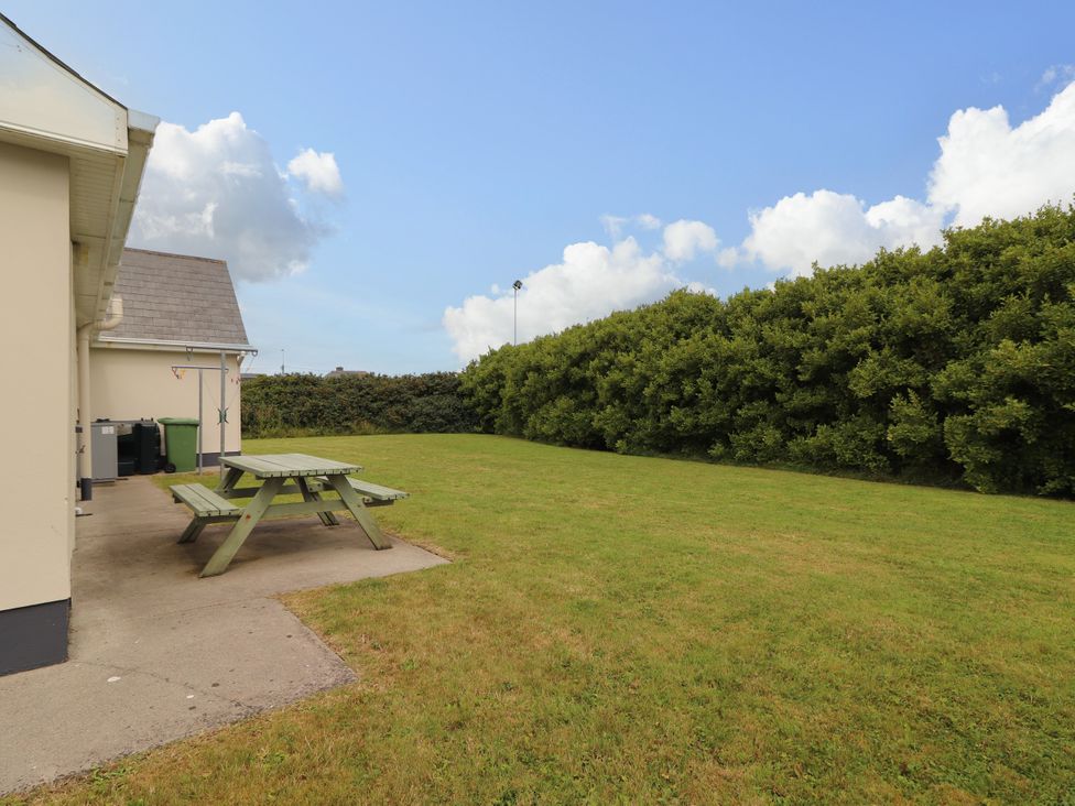 A garden with a table and grass at 29 Church Field in Doonbeg, County Clare