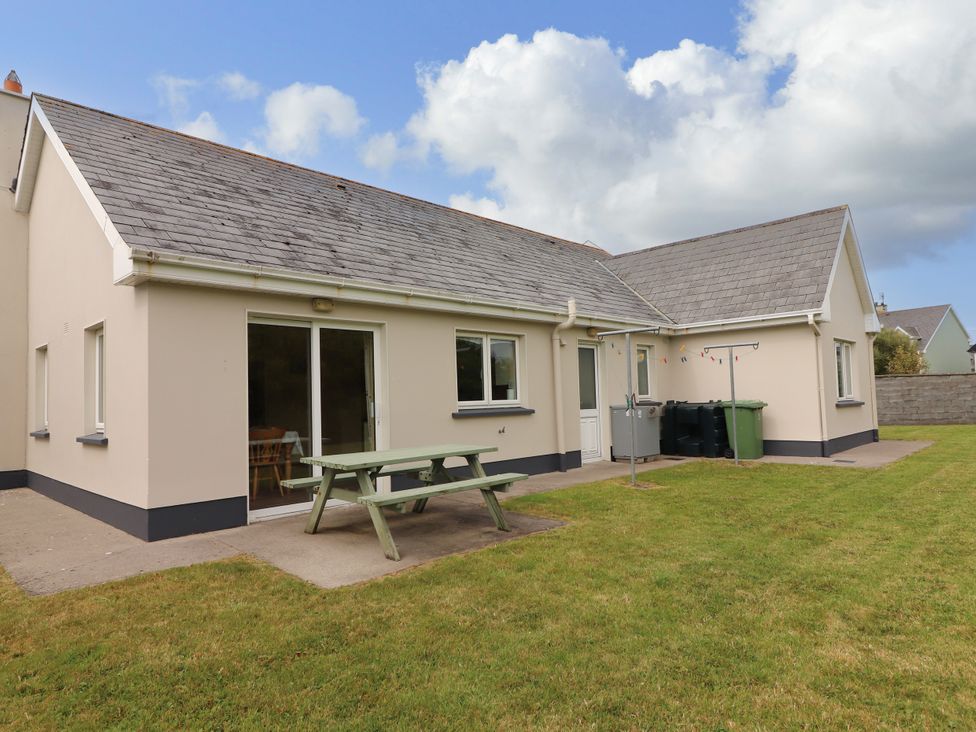A house with a table and chairs in an outdoor area at 29 Church Field in Doonbeg, County Clare