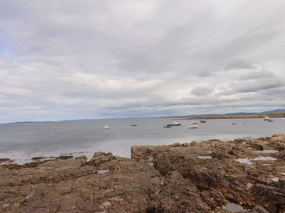 An ocean view with boats on the water at 29 Church Field, Doonbeg, County Clare