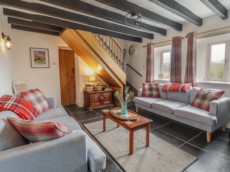 A living room with a sofa and coffee table at Alwyn Cottage Froncysyllte