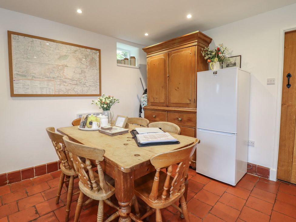 A kitchen with a table and chairs at Alwyn Cottage in Froncysyllte