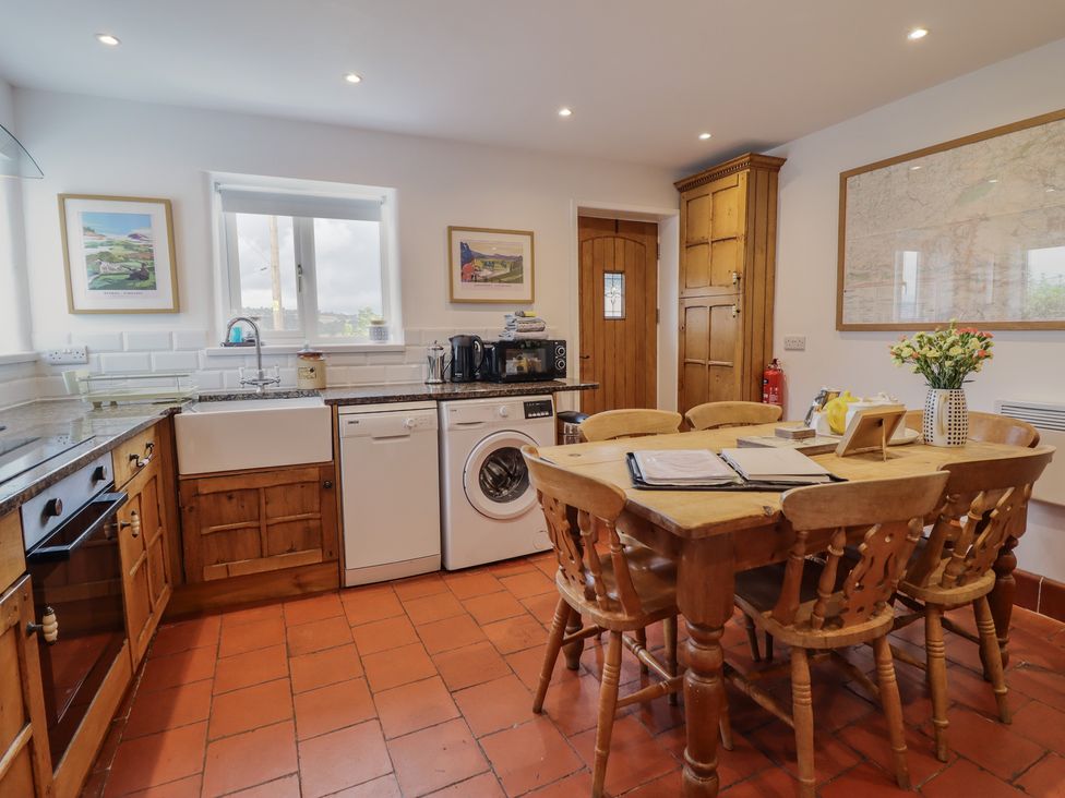 A kitchen with a table and chairs at Alwyn Cottage in Froncysyllte
