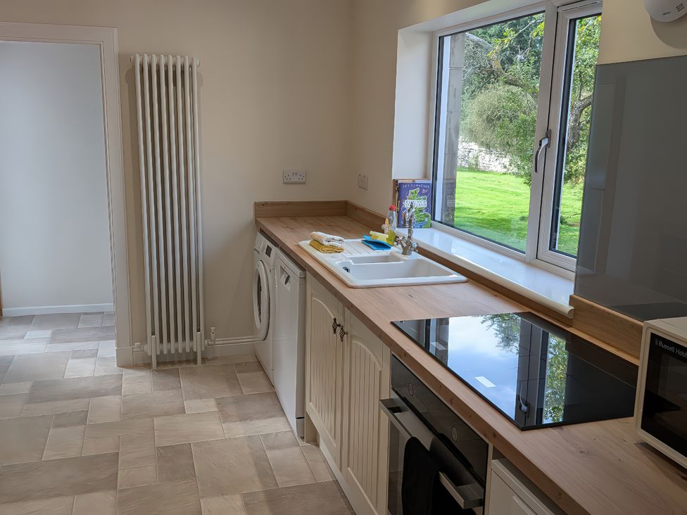A kitchen with appliances and a window at Edengrove in Aberfeldy