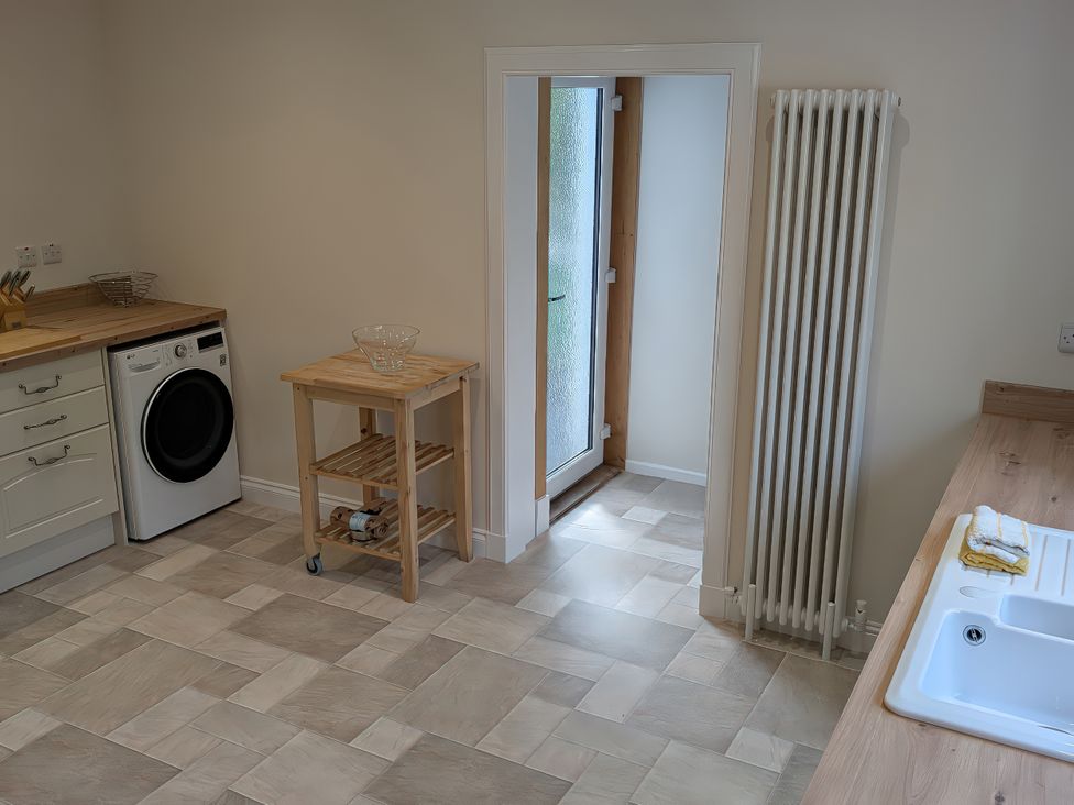 A kitchen with a washing machine and a sink at Edengrove in Aberfeldy