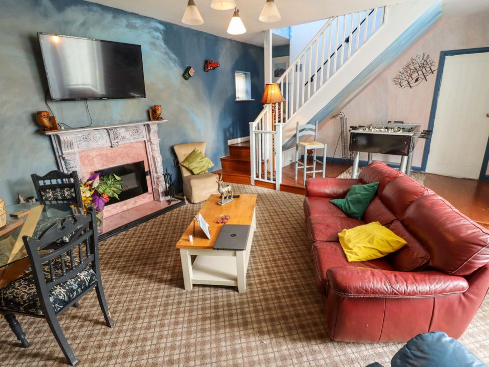 A living room with a sofa and coffee table at Peartree Cottage