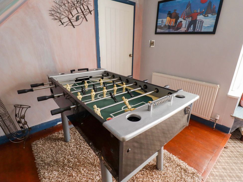 A foosball table in a game room at Peartree Cottage