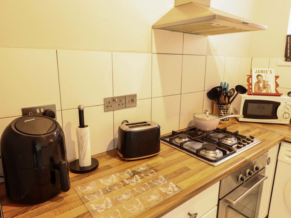 A kitchen with kitchen appliances on the countertop at Peartree Cottage