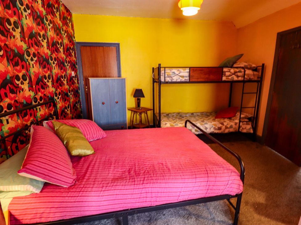 A bedroom with a bed and a bunk bed at Peartree Cottage