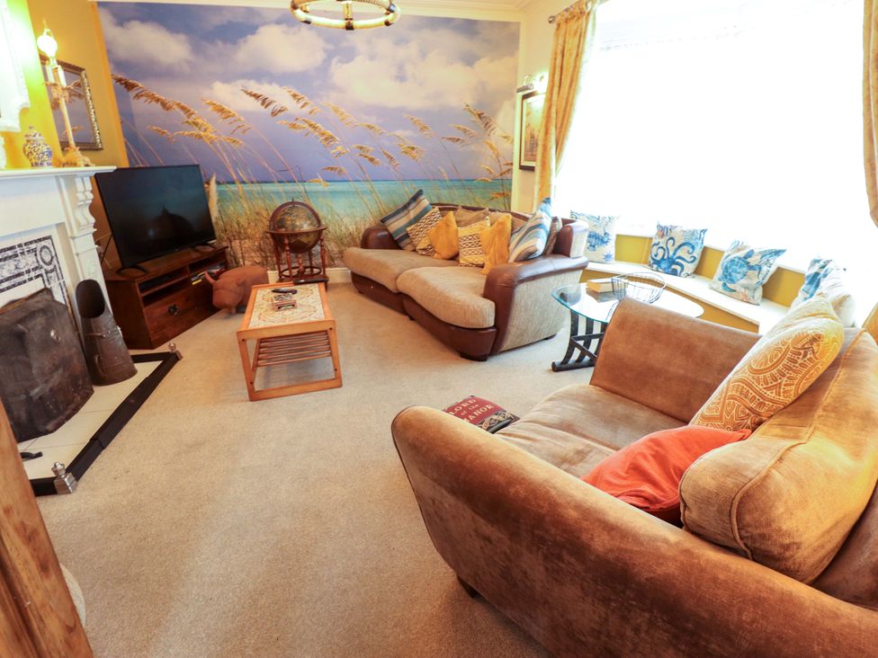 A living room with a sofa and television at Telford Lodge in Skegness