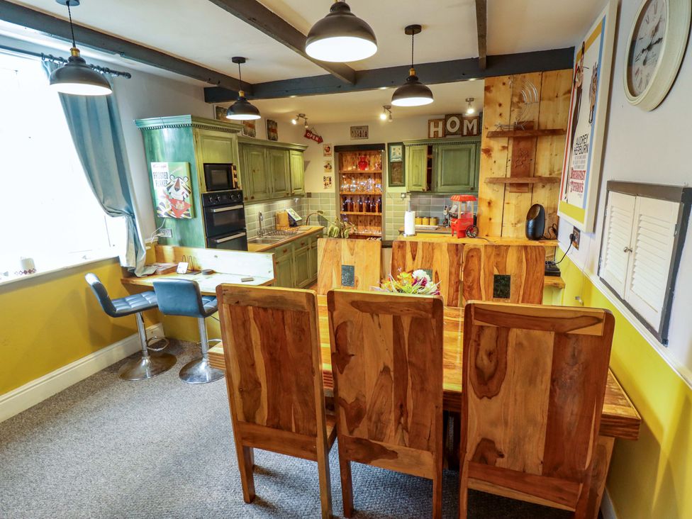 A kitchen with a table and chairs at Telford Lodge in Skegness