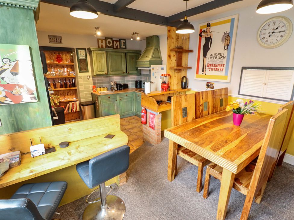 A kitchen with wooden furniture and appliances at Telford Lodge in Skegness