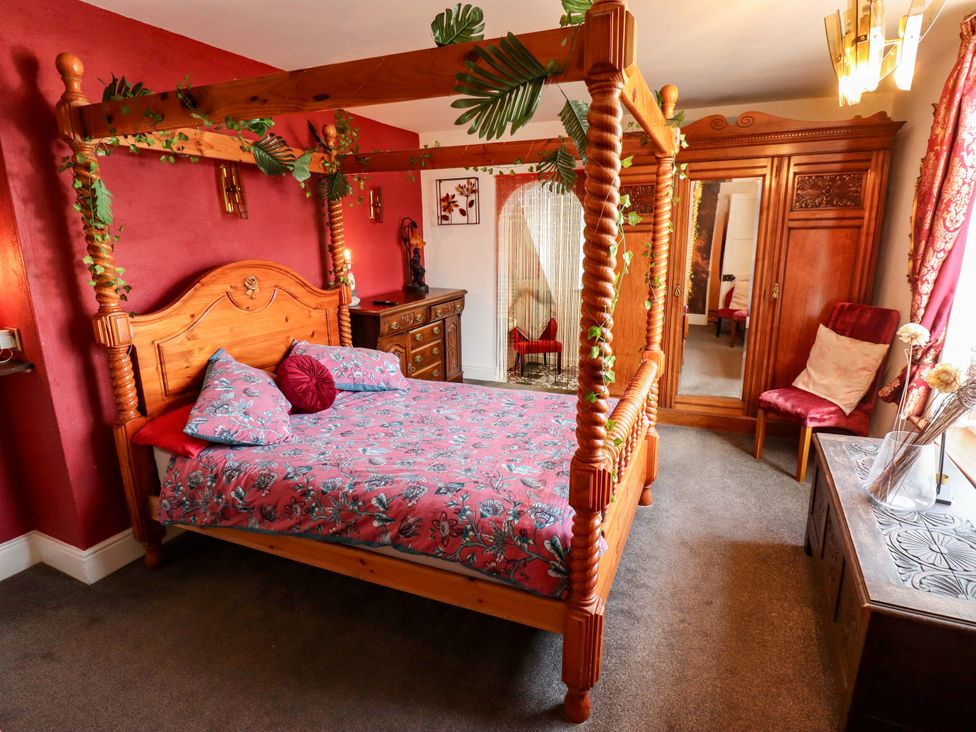 A bedroom with a four-poster bed and wardrobe at Telford Lodge in Skegness