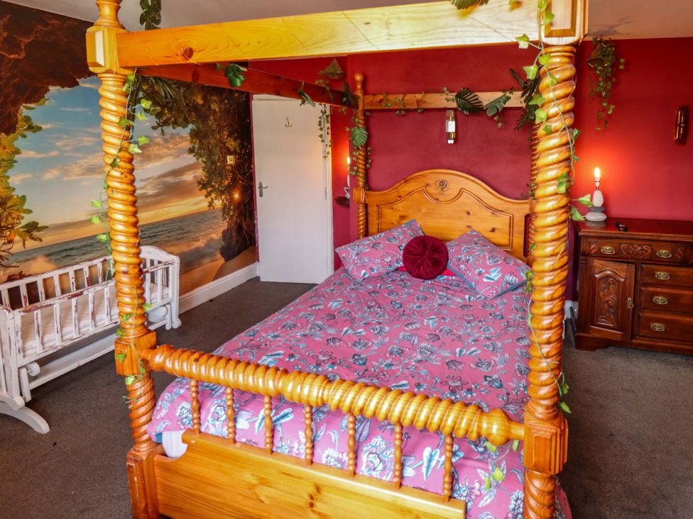 A bedroom with a four-poster bed and chest of drawers at Telford Lodge in Skegness