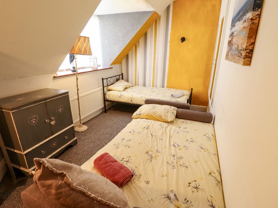 A bedroom with two beds and a chest of drawers at Telford Lodge in Skegness