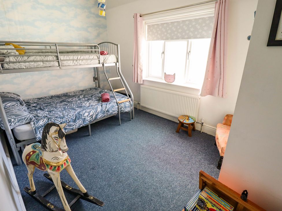 A bedroom with a bunk bed and rocking horse at Telford Lodge in Skegness