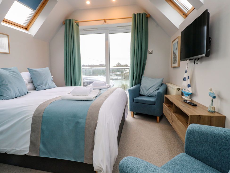A bedroom with a bed and television at Alltwen in Borth-y-Gest