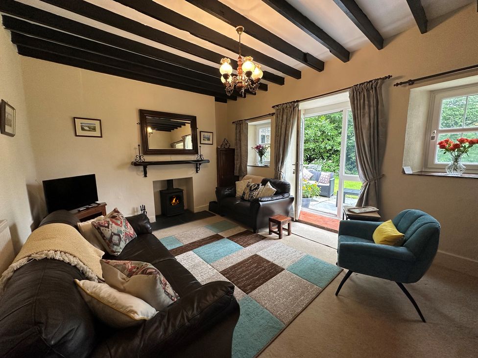 A living room with a sofa and television at Parke Cottage Henllan Amgoed near Whitland