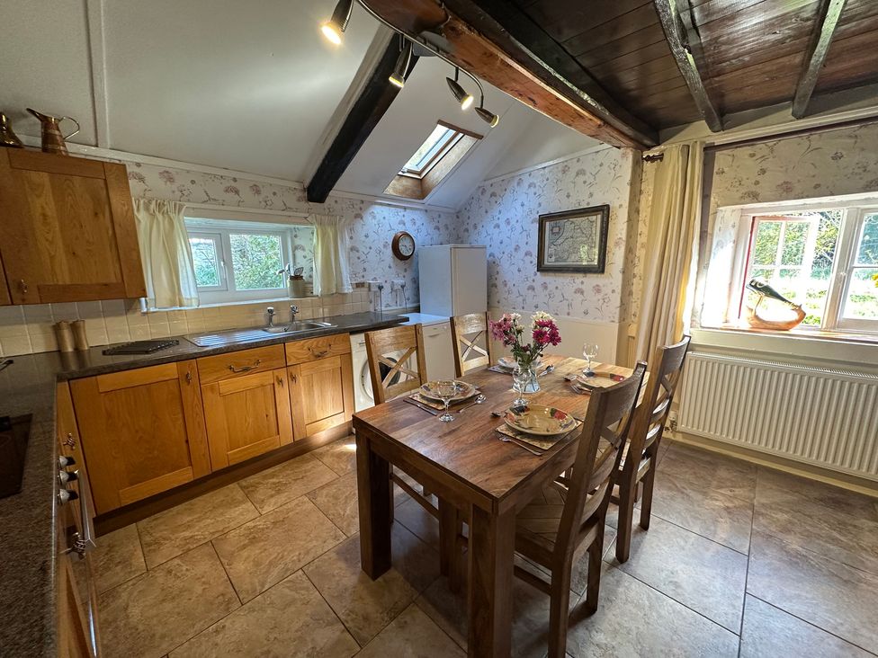 A kitchen with a dining table and chairs at Parke Cottage Henllan Amgoed near Whitland