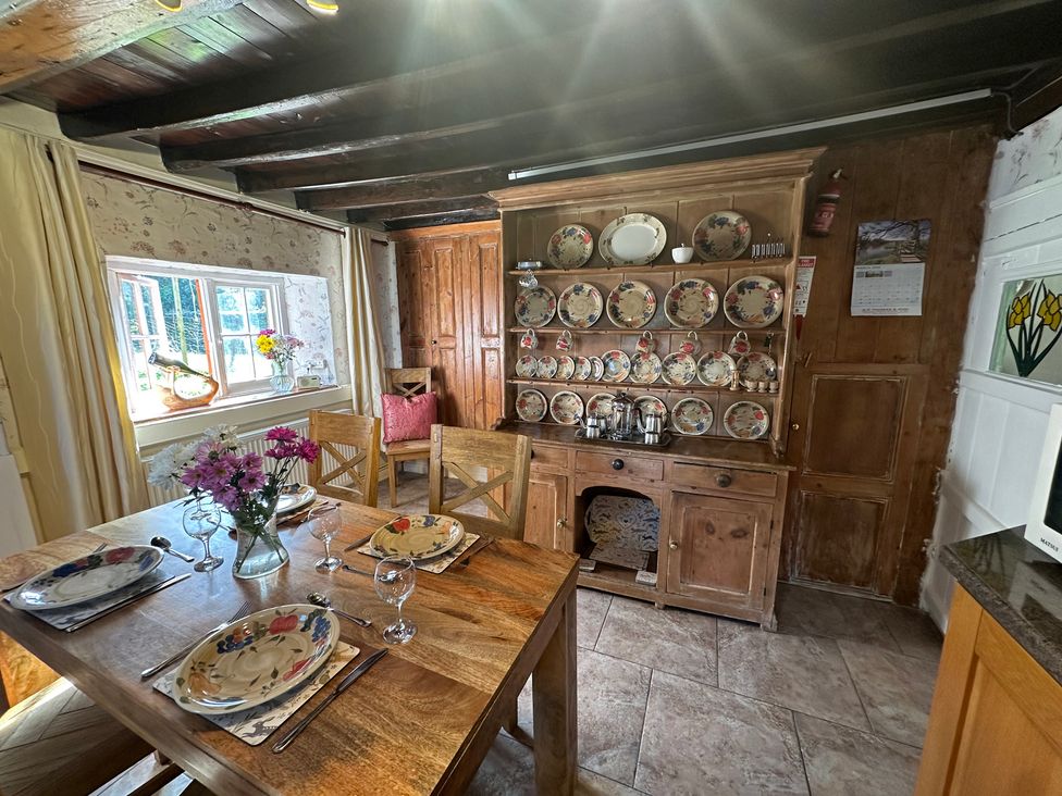 A dining room with a table set for meals at Parke Cottage Henllan Amgoed near Whitland