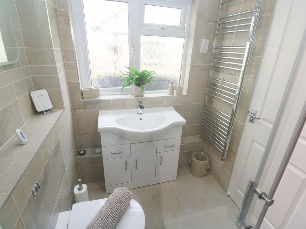 A bathroom with a sink and toilet at Driftwood in Marazion