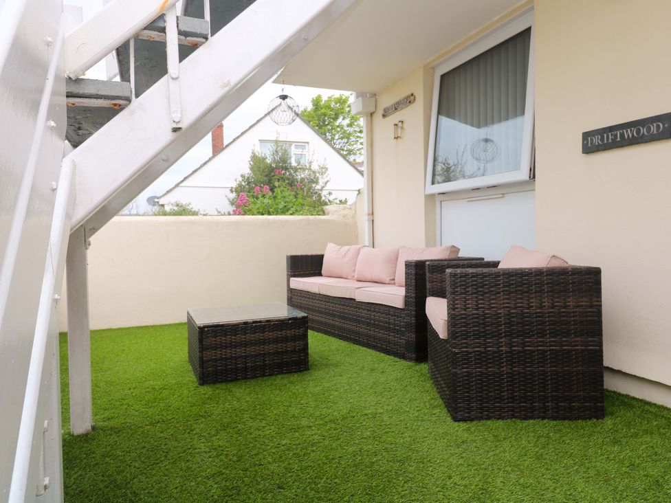 An outdoor seating area with furniture at Driftwood in Marazion