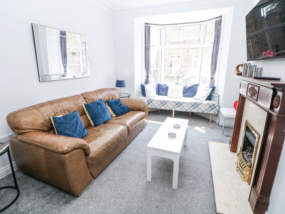 A living room with a sofa and coffee table at 15 South Avenue Mews in Buxton