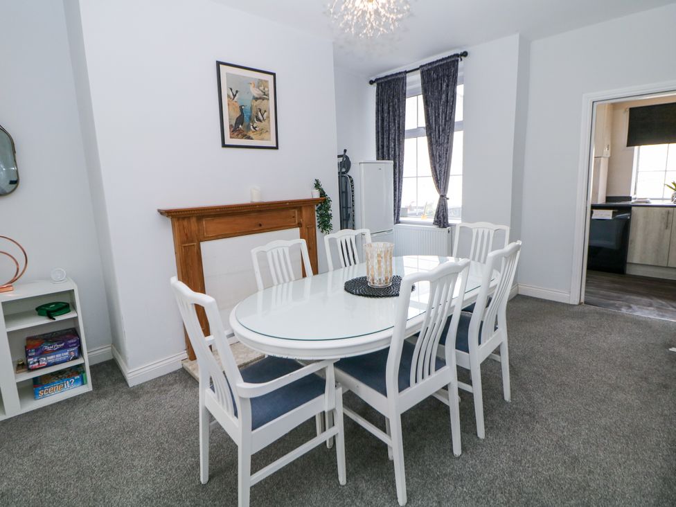 A dining room with a table and chairs at 15 South Avenue Mews in Buxton