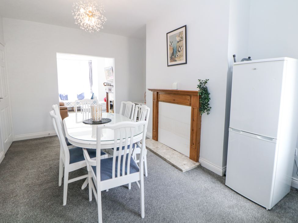 A dining room with a table and chairs at 15 South Avenue Mews Buxton