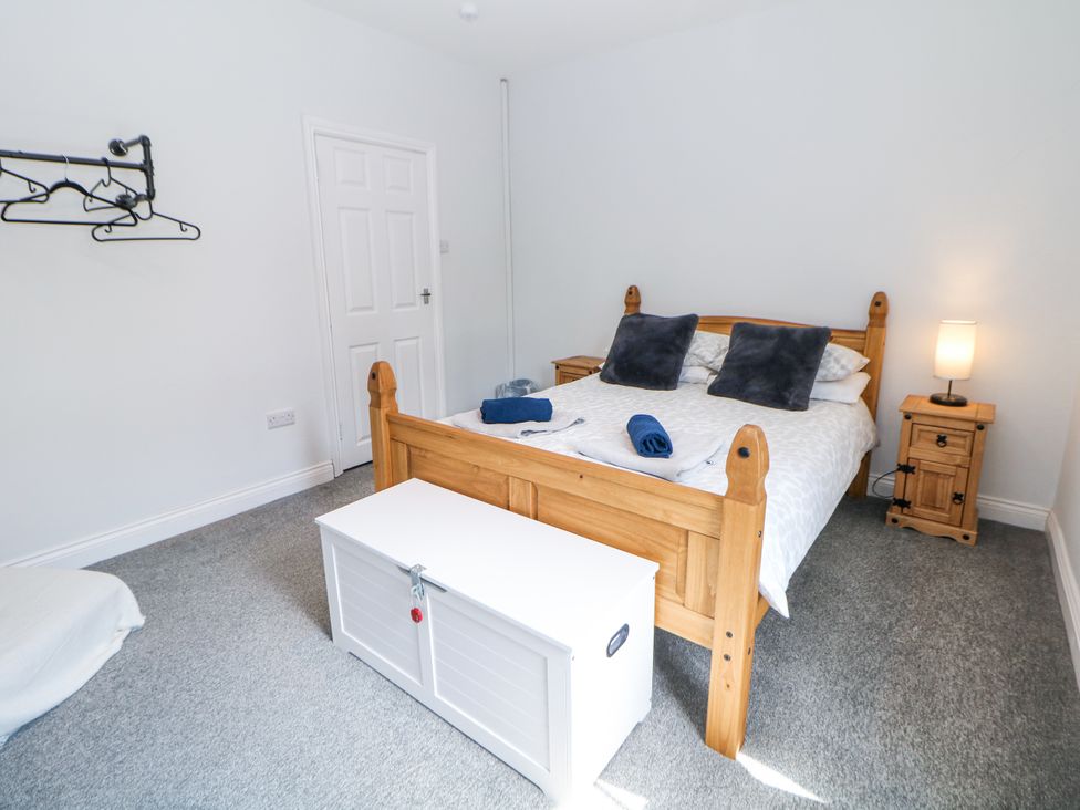 A bedroom with a bed and storage box at 15 South Avenue Mews Buxton