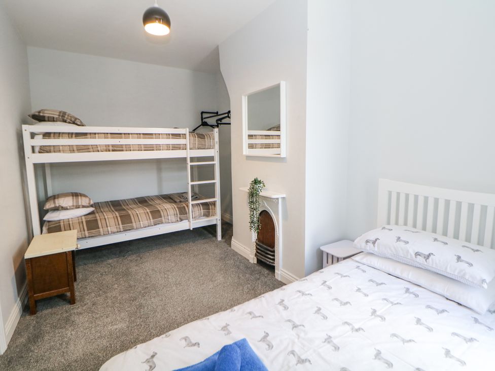 A bedroom with a bunk bed and a single bed at 15 South Avenue Mews Buxton