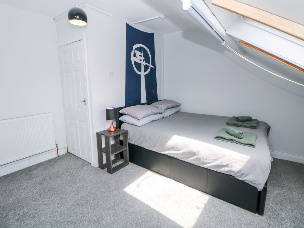 A bedroom with a bed and bedside table at 15 South Avenue Mews Buxton